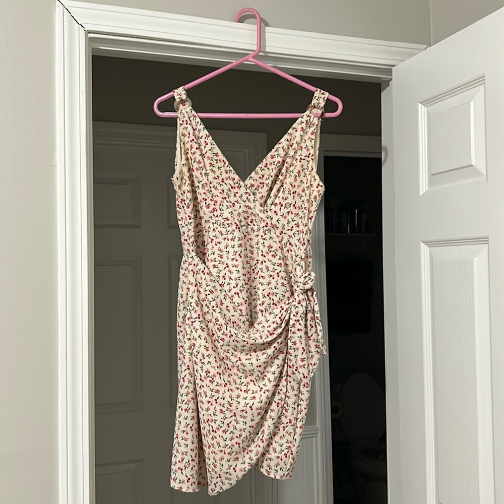 White floral dress with pink flowers. Ties at the waist.